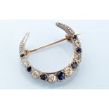 A diamond and sapphire set Edwardian crescent brooch,