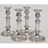A set of four 19th Century plated extending candlesticks, with bands of floral design,