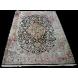 A Cashmere carpet, with full floral decoration, the outer borders on a pink ground,