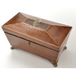 An early 19th Century mahogany sarcophagus form tea caddy, decorated with stringing,