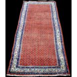 A Surok Maher runner, with boteh motifs on red ground, 311 x 112cms (122 1/2 x 44in.).