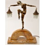 After Marcel Bouraine: an Art Deco patinated, gilt bronze and ivory-coloured composition table lamp,
