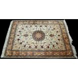 A Tabriz rug, the ivory ground with scrolling floral design, 198 x 156cms (78 x 61 1/2in.).