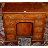 A George I style walnut kneehole desk,