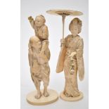 Japanese Meiji period ivory figure group of man carrying a boy,