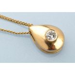 A diamond pendant, the brilliant cut diamond in collet setting, within yellow metal pear drop mount,