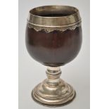 A Continental white metal mounted coconut cup, the coconut bowl with white metal rim,
