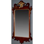 A George III style mahogany and parcel gilt wall mirror, decorated with scrolls and ho-ho bird,