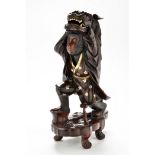 A 19th Century Japanese patinated and gilt bronze Anthropomorphic monkey,