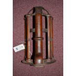 A cast iron and mahogany wall bracket for hanging a bridle and a collar,