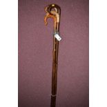 Four shepherd's style hazel walking sticks with hand-carved wooden handles, in various woods,