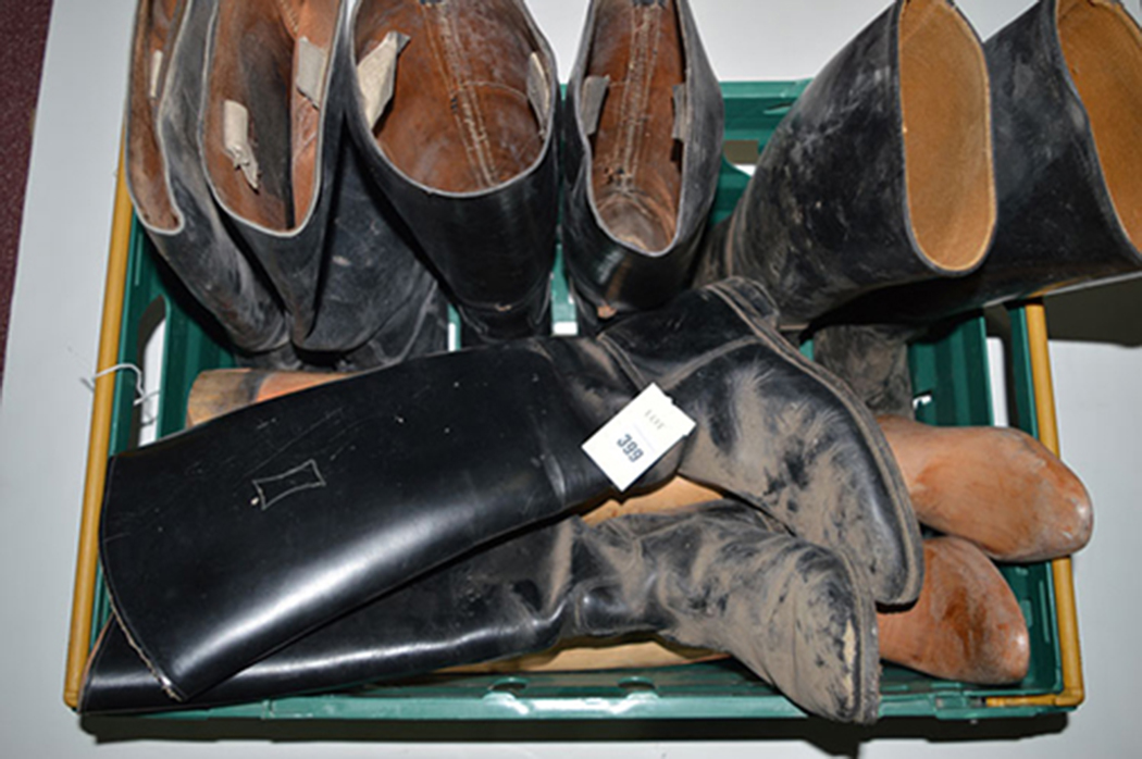 Four pairs of black leather riding boots, various; and a pair of wooden trees (incomplete).