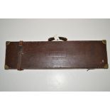 A leather on wood gun case, with brass corner and clasp,