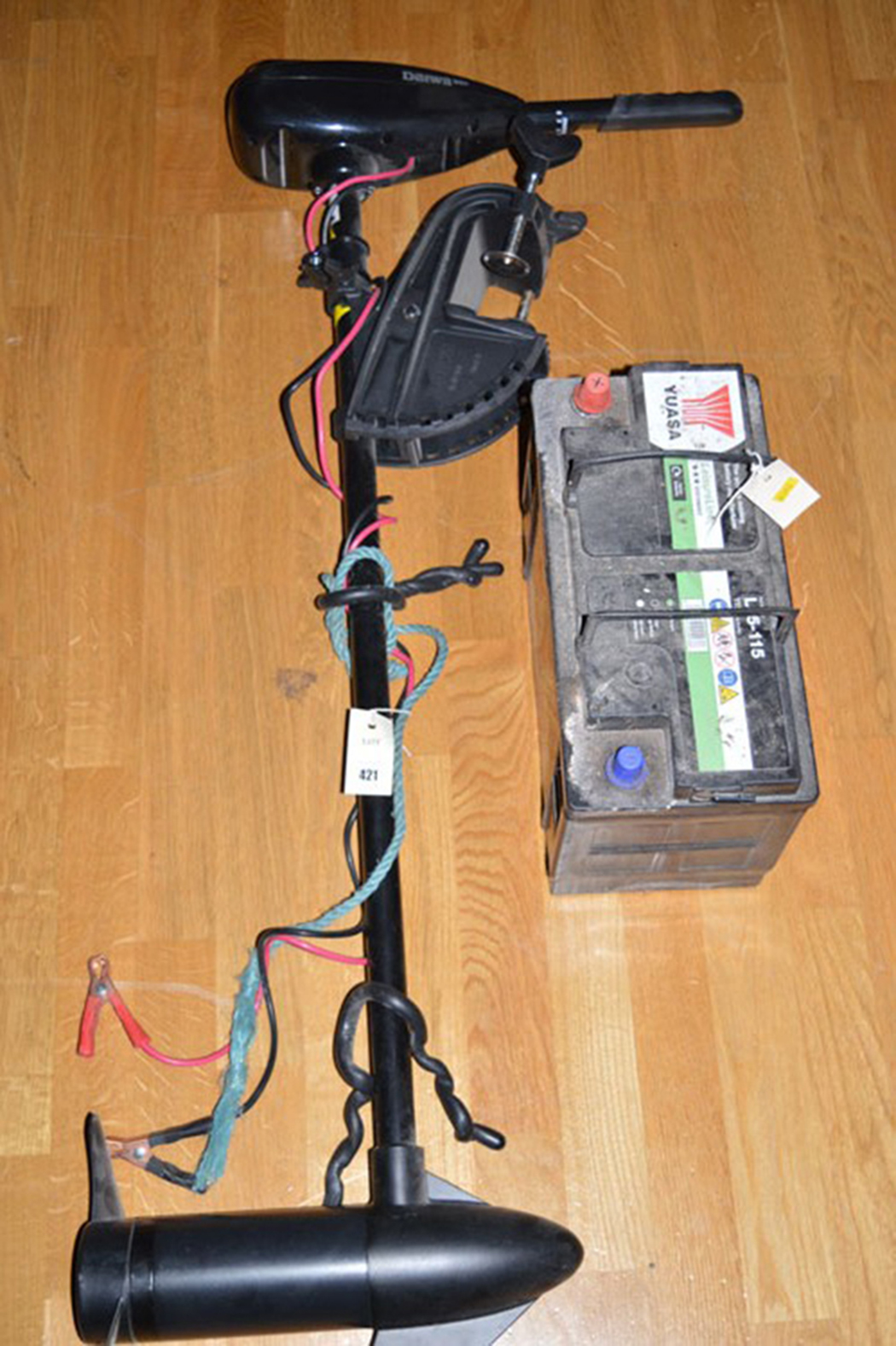 A Daiwa Model 36T electric battery operated outboard motor, motor instructions; and a battery.