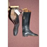 A pair of lady's black riding boots with trees, spurs and boot lifts.