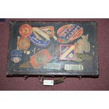 An early 20th Century suitcase covered in various luggage labels,
