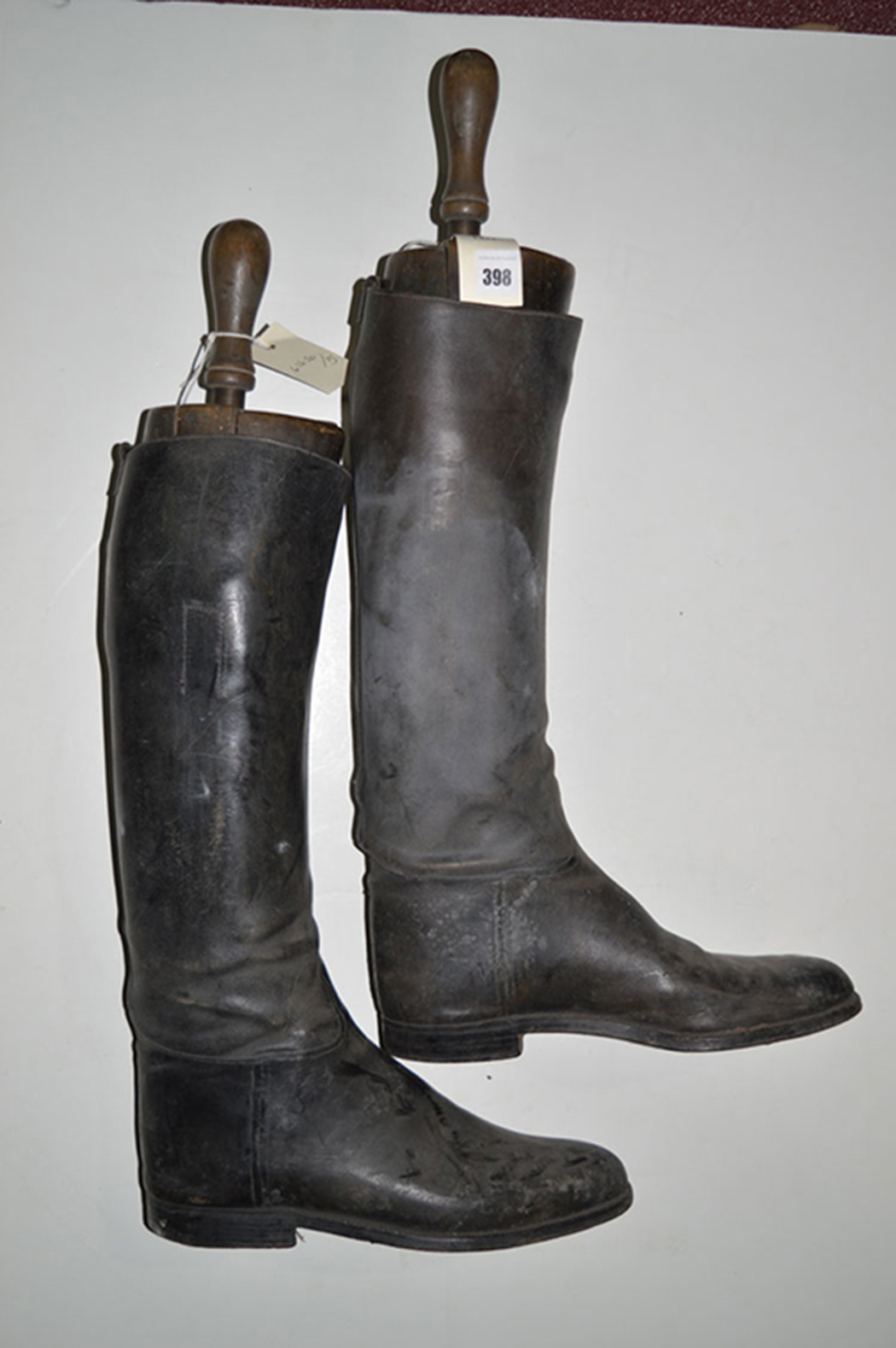 A pair of black leather riding boots, with wooden trees by Rowell & Sons, Market Place,