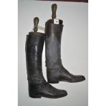 A pair of black leather riding boots, with wooden trees by Rowell & Sons, Market Place,