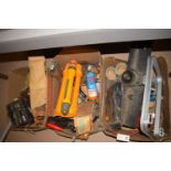 A collection of miscellaneous: hand tools; a battery charger; a foot pump;