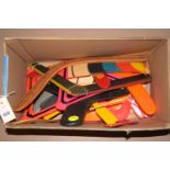 A collection of plastic and wooden boomerangs and other throwing toys.