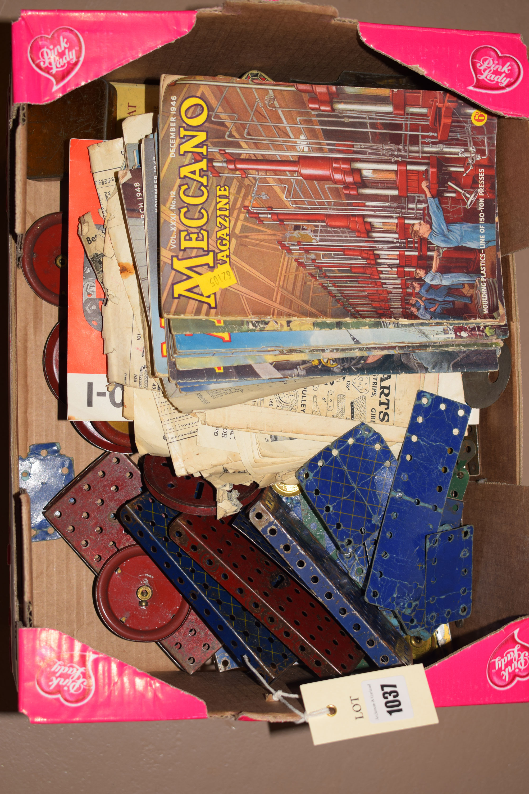 A collection of old Meccano; Meccano magazines; and a wooden box.