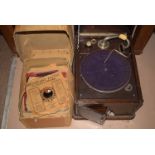 A wind-up gramophone in stained oak box; together with a quantity of records.