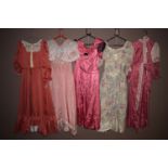 Theatre costumes - Victorian style dresses in pink, and floral patterns.
