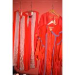 Two red university gowns, by Whipple & Co. Ltd, Exeter; together with two others.