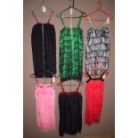 Six flapper style dresses with tassel and sequin decoration; in grey, green, black, pink and red.