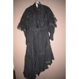 A black crepe Victorian jacket and skirt with quatrefoil sleeves.