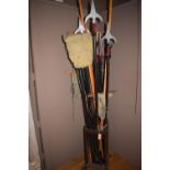 Theatre props, to include: spears and flags in a stained wood coat and stick stand.