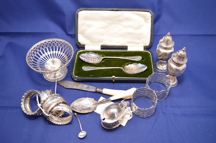 A silver pierced footed bowl, by Walker & Hall, Birmingham, 1921; a pair of berry spoons,