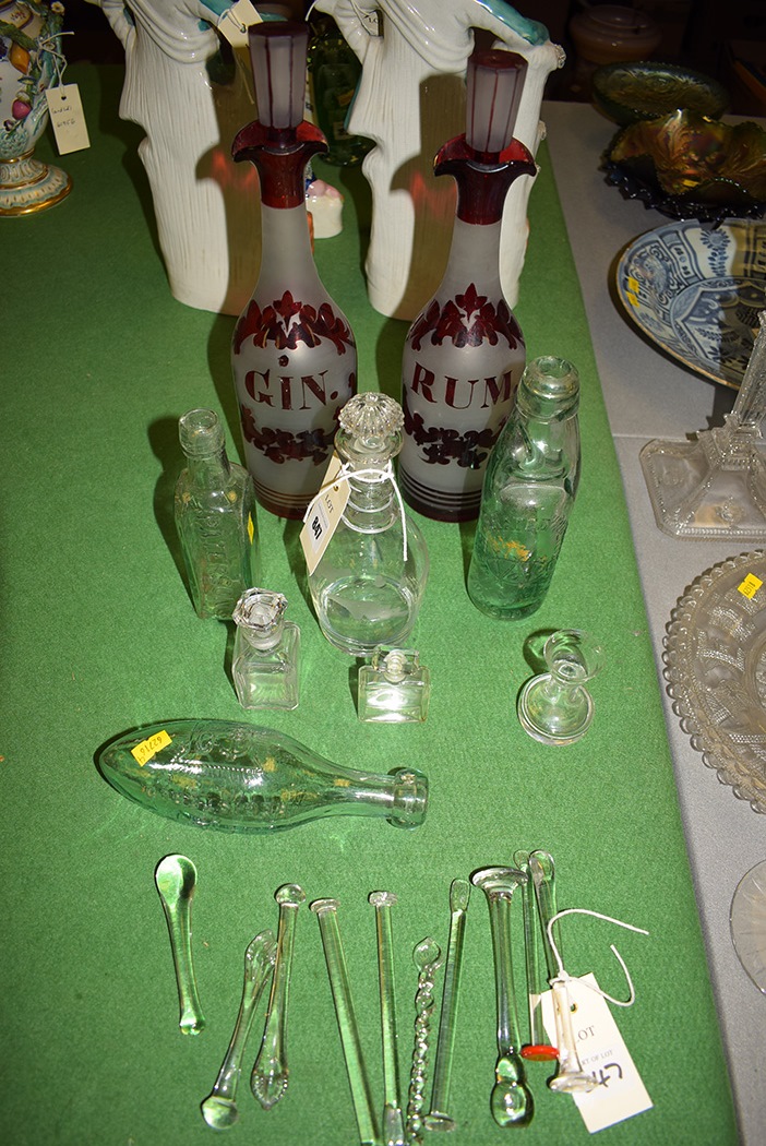 Two red and frosted glass decanters 'Gin' and 'Rum'; a glass bottle by 'The Aerated Water Company';