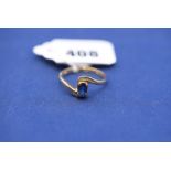 A sapphire and diamond ring, in crossover mount, 9ct. yellow gold shank, ring size R.