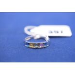 A gemstone and diamond ring, in channel setting, on 9ct. white gold shank, ring size R.