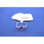 An amethyst and diamond ring, on 9ct. white gold shank, ring size R.