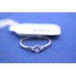 A tanzanite and diamond ring, on 9ct. white gold shank, ring size T.