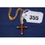 A spessartine garnet and diamond cross pattern pendant, in 9ct. yellow gold mount on chain.