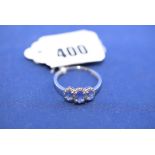 A three stone tanzanite and diamond cluster ring, on 9ct. white gold shank, ring size S.