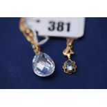 A cubic zirconia drop in gold mount on chain; together with a blue topaz drop pendant.