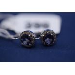 A pair of amethyst and diamond cluster earrings, in 9ct. white gold mounts.