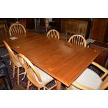 Mid 20th Century teak extending dining table, three spare leaves,