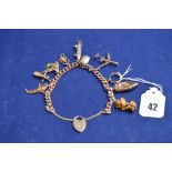 A 9ct yellow gold curb link charm bracelet with eleven charms, 41.2grms.