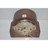 A 20th Century mantel clock by Enfield, arabic dial, in stained oak case.