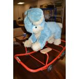 A Pedigree Soft Toys Ltd. blue rabbit, on red painted metal frame, raised on rubber wheels.