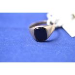 A 9ct yellow gold and black onyx signet ring, 3grms gross.