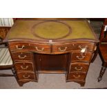 A Reproduction mahogany kneehole desk, inset green leather top,