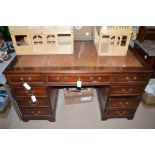 A reproduction mahogany kneehole desk,