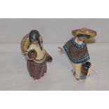 Two Lladro figures of a boy and girl carrying stoneware jugs and wearing sombreros.