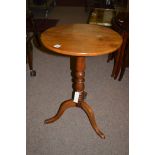 A mahogany circular tip-up-top wine table, raised on tripod feet.